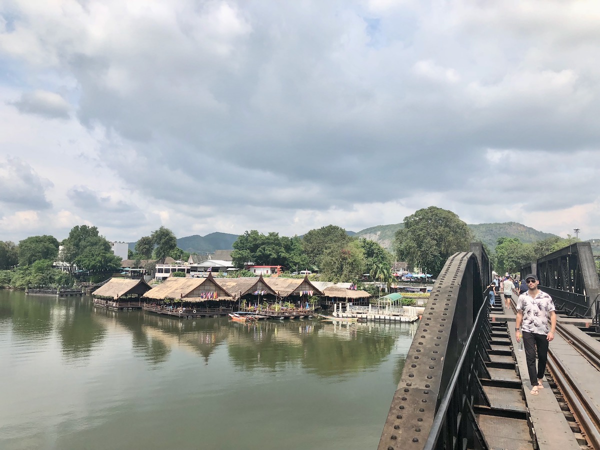 A male tourist walks over the River Kwai Bridge in Kanchanaburi, Thailand. 