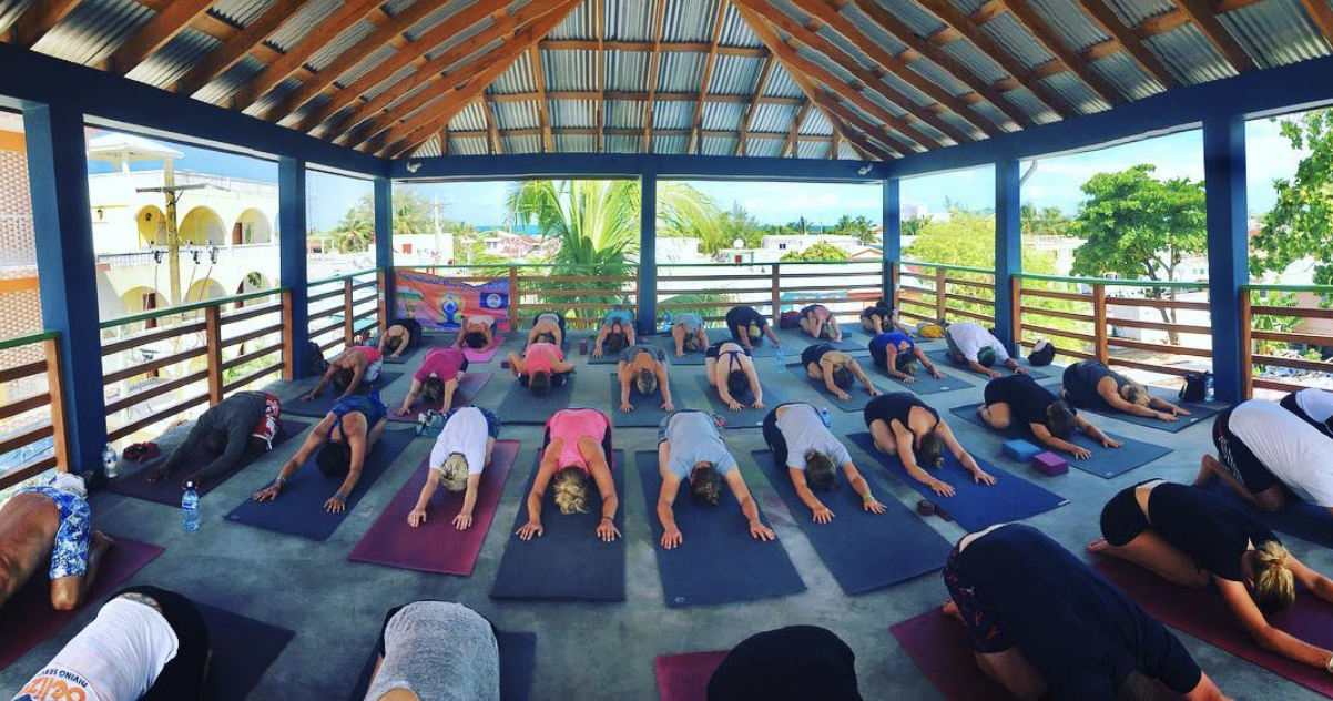 A class doing rooftop yoga in Belize