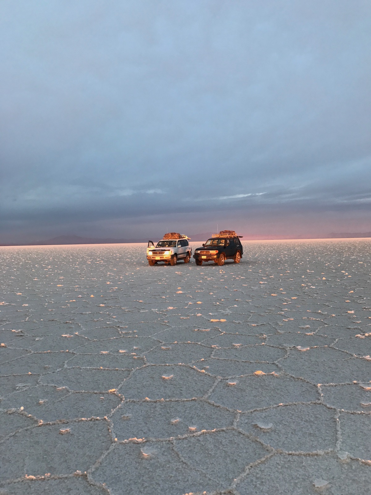 Two jeeps in the middle of the desert in Salar de Uyuni, Bolivia.