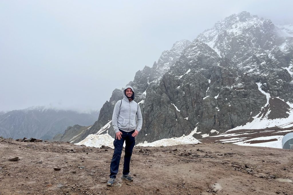 Snow-covered peak shrouded in low cloud at Shymbulak mountain resort near Almaty