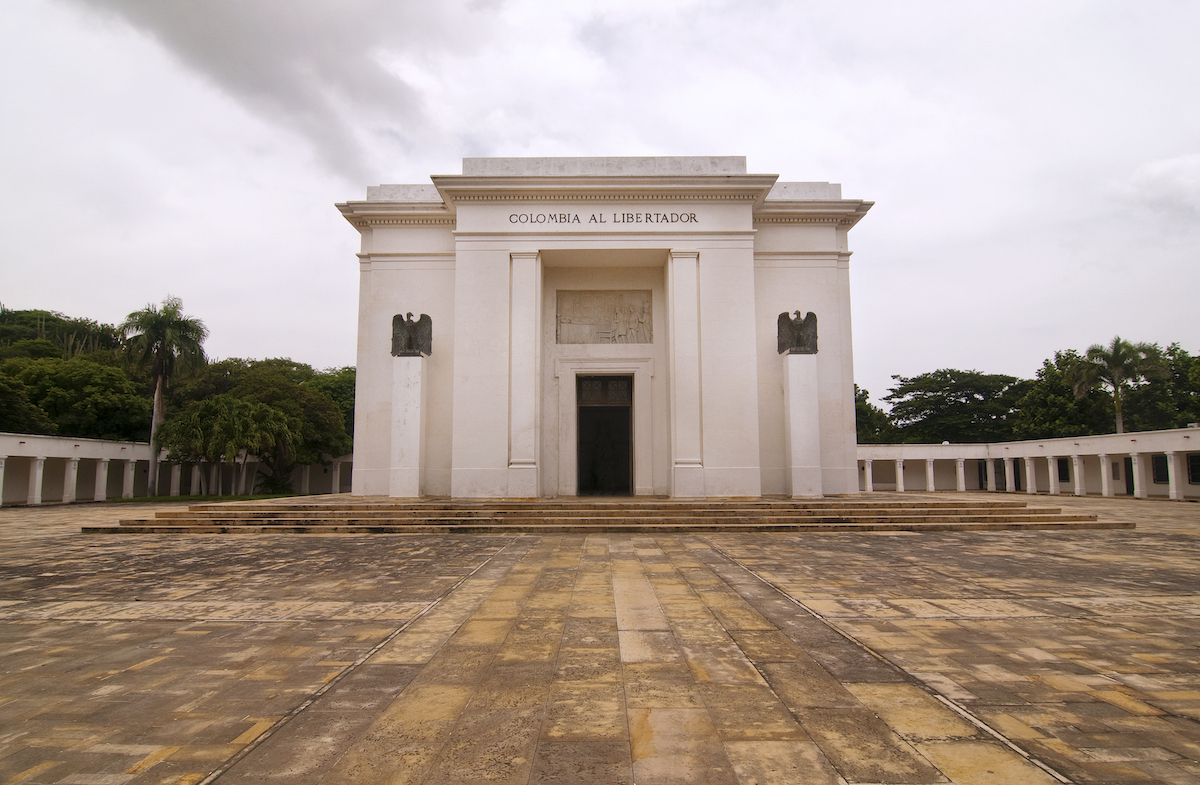 A white monument with the words' Colombia Al Libertador' in capital letters above the door.