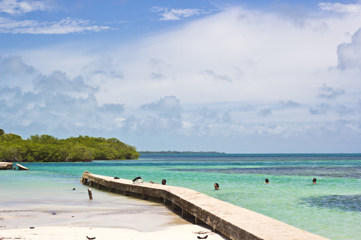 People swim in the sea at the Split region, on Caye Caulker, Belize