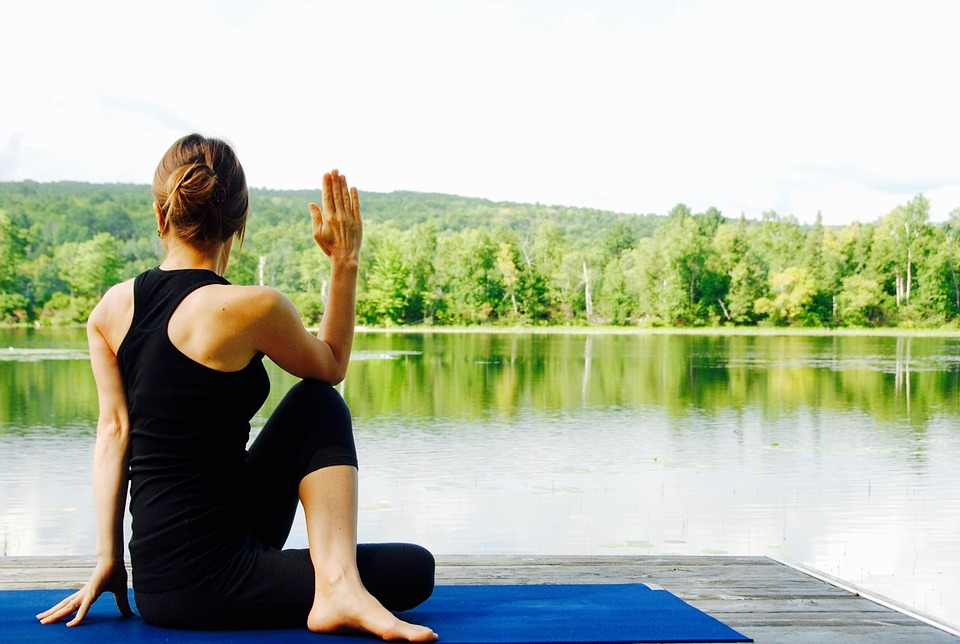 A woman doing a gentle stretch on a mat
