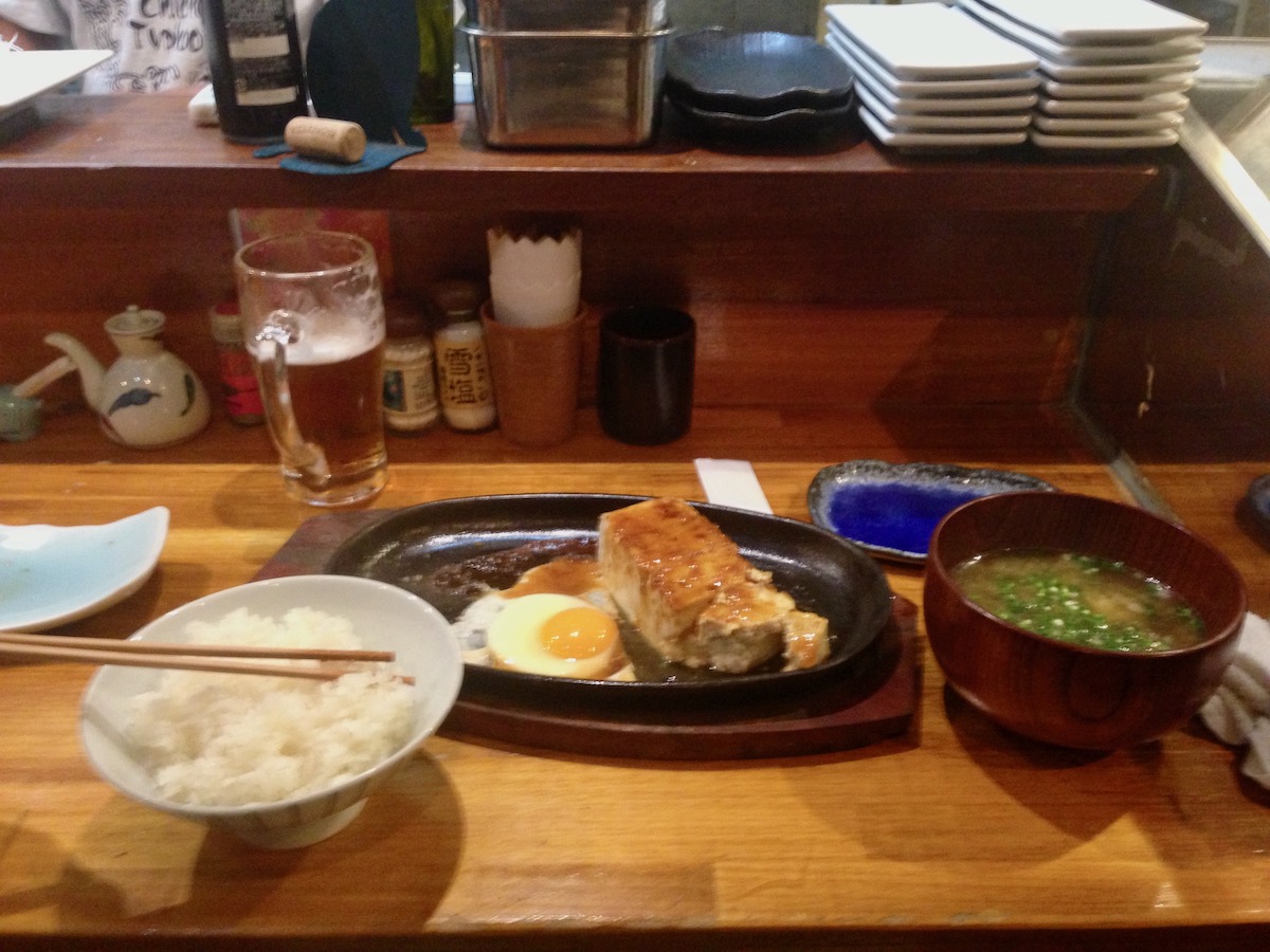 An Okinawan meal consisting of white rice, tofu, egg and miso soup